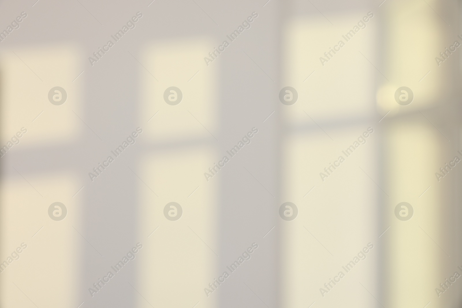 Photo of Light and shadows from window on wall indoors