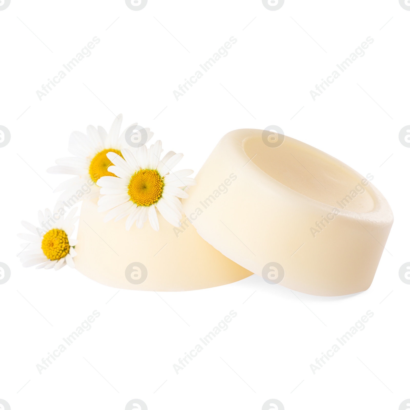 Photo of Solid shampoo bars and chamomiles on white background. Hair care