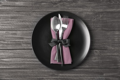 Beautiful table setting on dark wooden background, top view