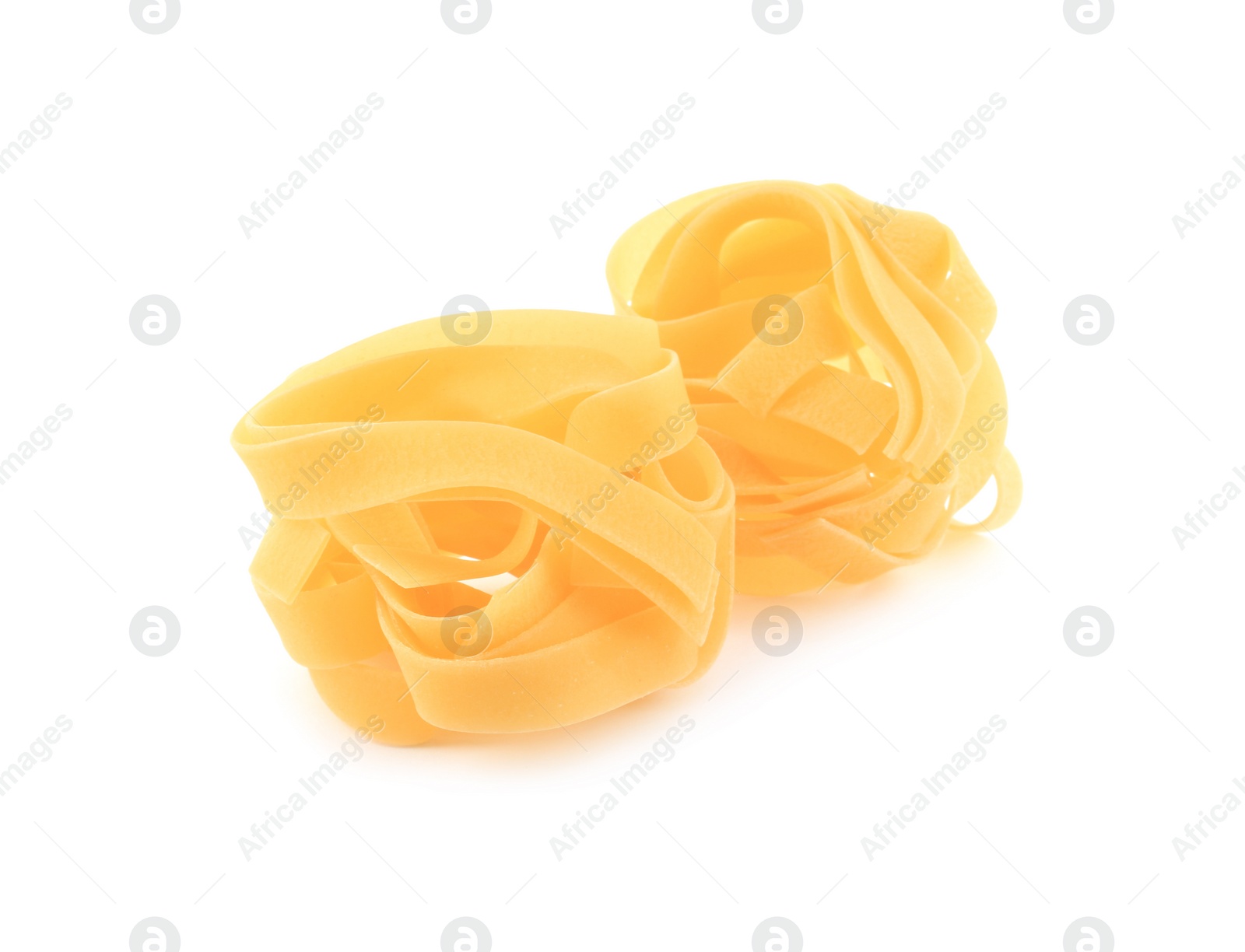 Photo of Raw fettuccine pasta isolated on white. Italian cuisine