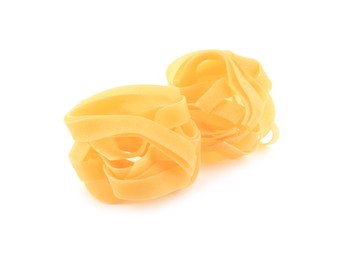 Raw fettuccine pasta isolated on white. Italian cuisine