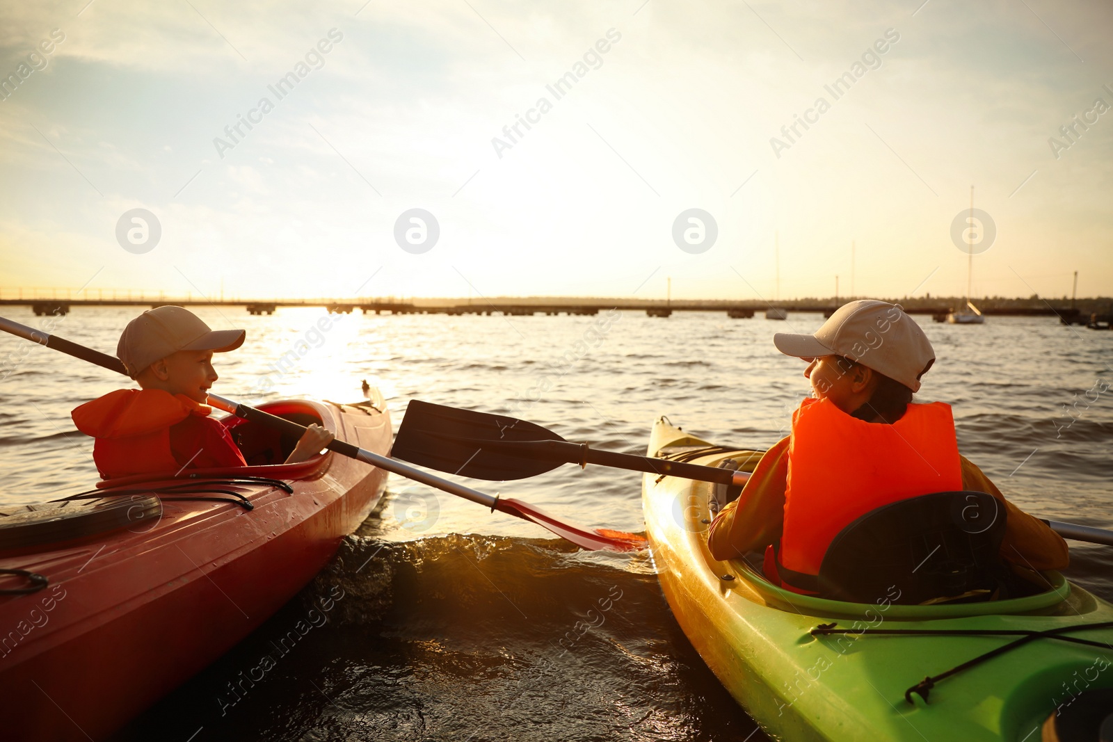 Photo of Little children kayaking on river. Summer camp activity