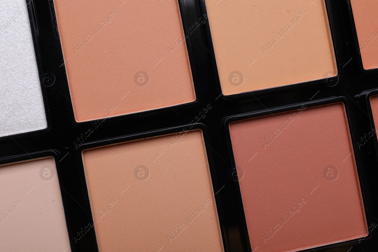 Photo of Colorful contouring palette as background, closeup. Professional cosmetic product