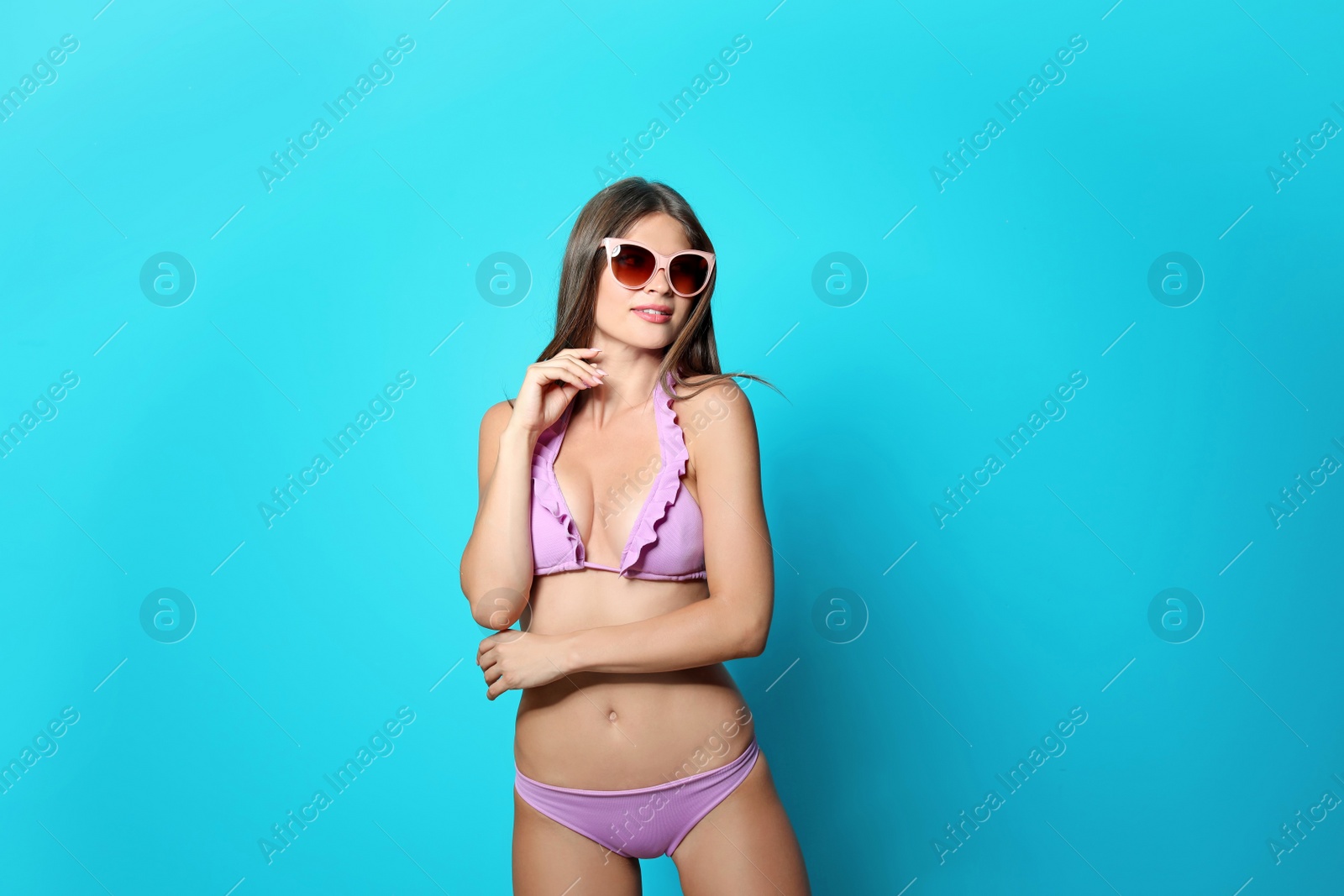 Photo of Sexy young woman in bikini on color background