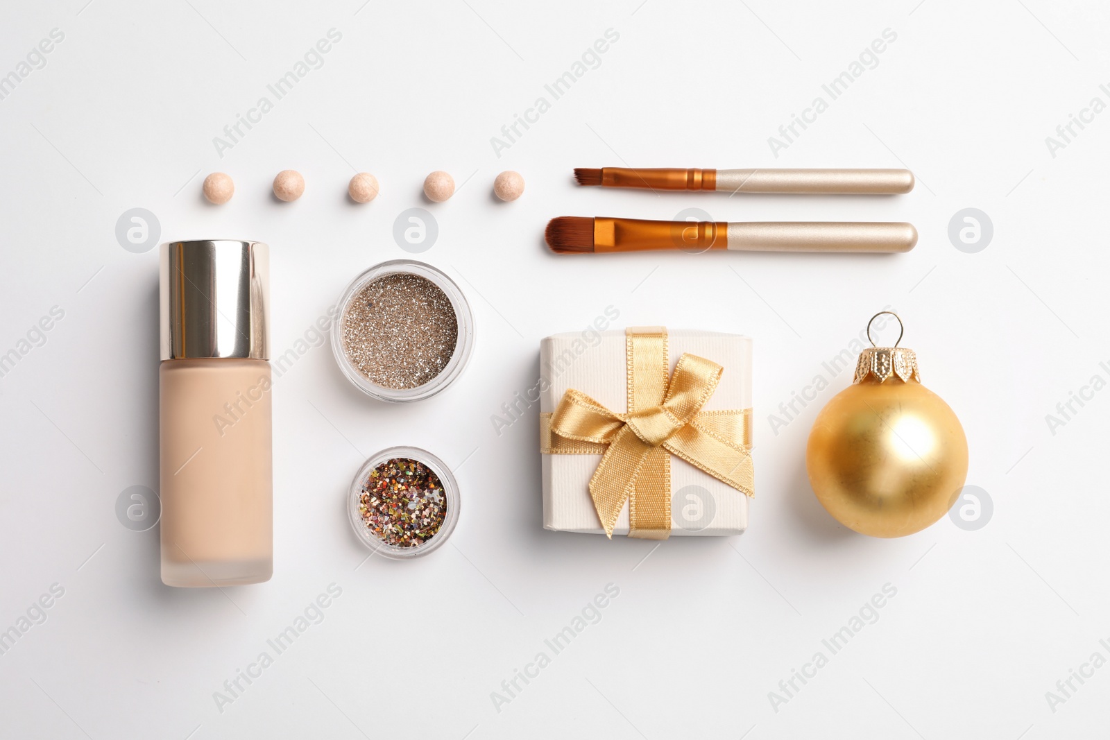 Photo of Flat lay composition with makeup products and Christmas decor on white background