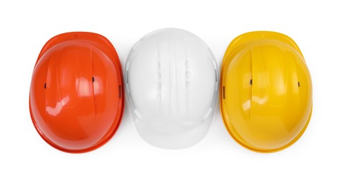 Photo of Hard hats isolated on white, top view. Safety equipment