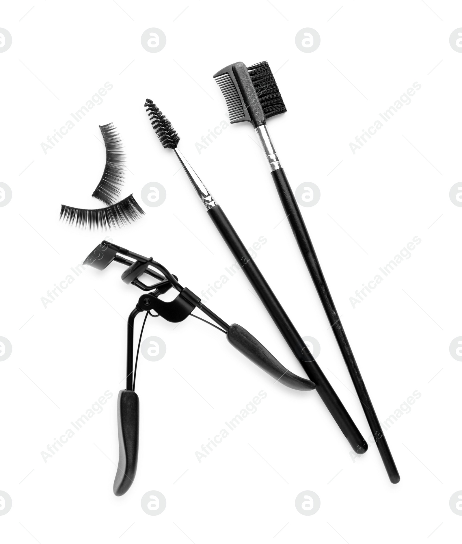 Photo of False eyelashes, curler and brushes on white background, top view