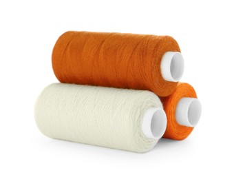 Photo of Different colorful sewing threads on white background