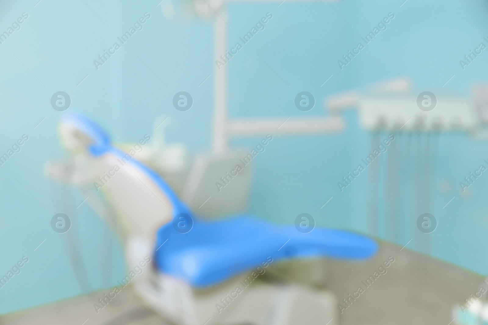 Photo of Blurred view of dentist's office with chair and professional equipment
