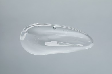 Photo of Sample of cleansing gel on light grey background, top view. Cosmetic product