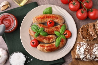 Photo of Flat lay composition with tasty homemade sausages, basil leaves and tomatoes on brown table