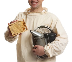 Photo of Beekeeper in uniform holding smokepot and hive frame with honeycomb on white background, closeup
