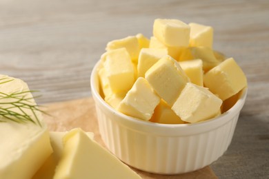 Pieces of tasty butter on wooden table, closeup