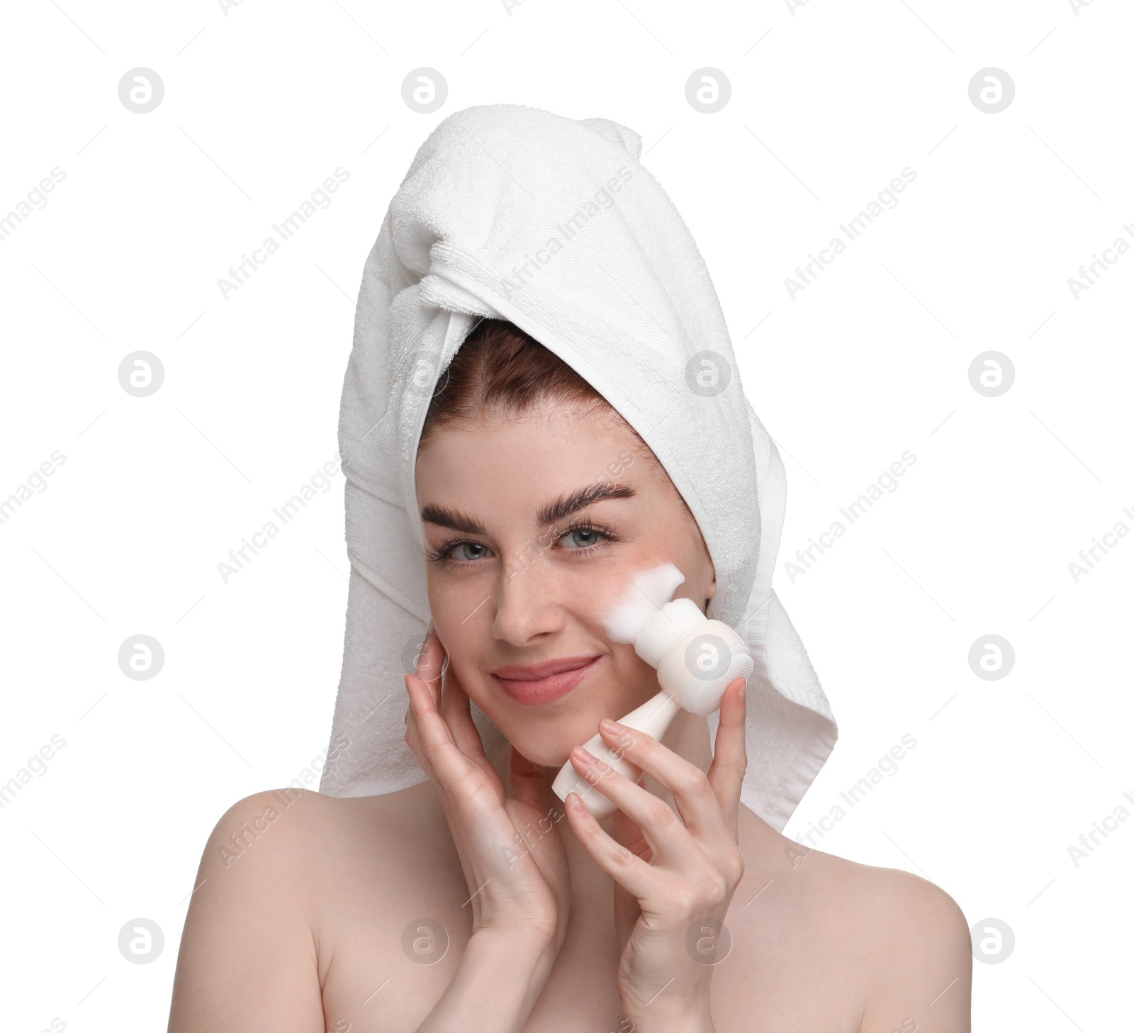 Photo of Young woman washing face with brush and cleansing foam on white background