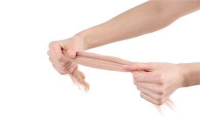 Woman holding beige felting wool on white background, closeup