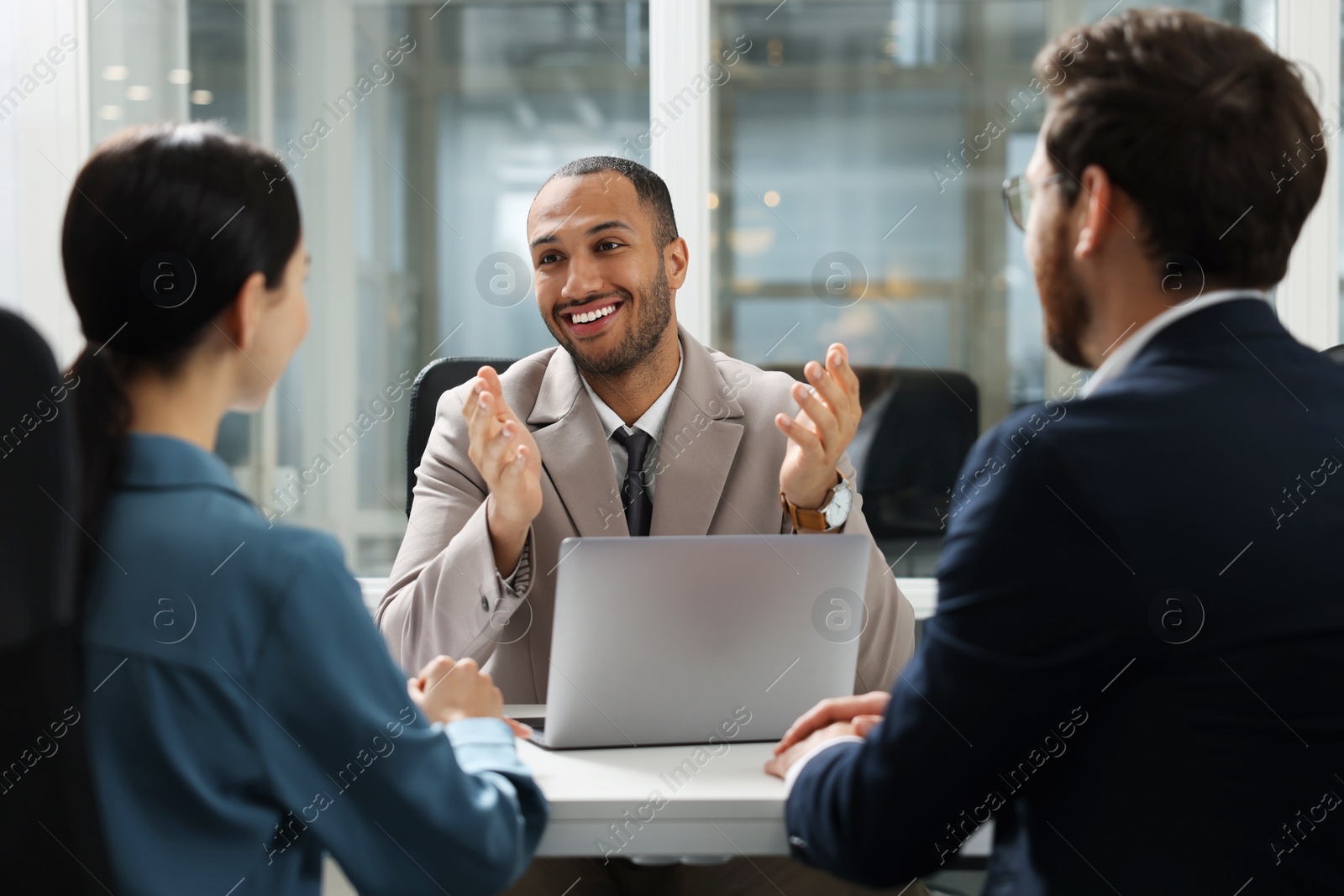 Photo of Lawyer working with clients at table in office