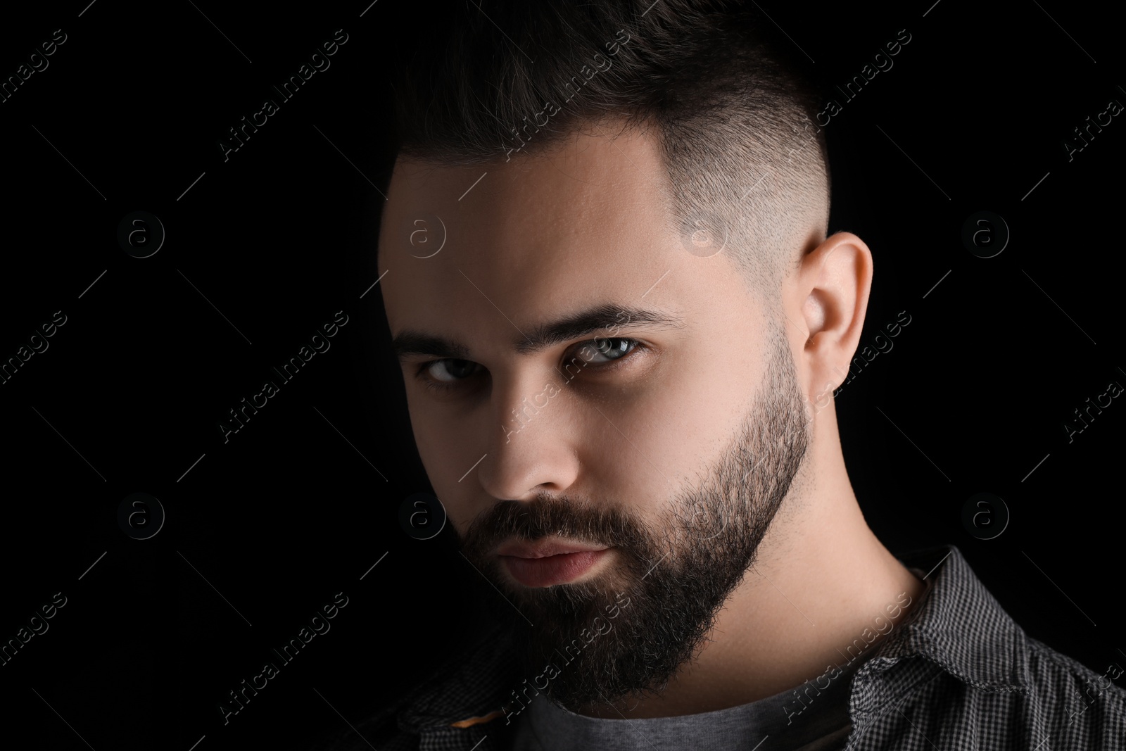 Photo of Evil eye. Man with scary eyes on black background