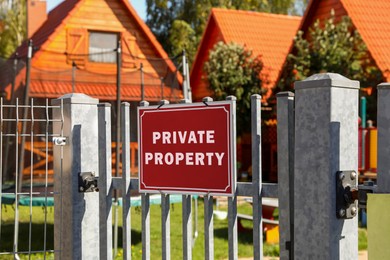 Image of Red sign with text Private Property on fence