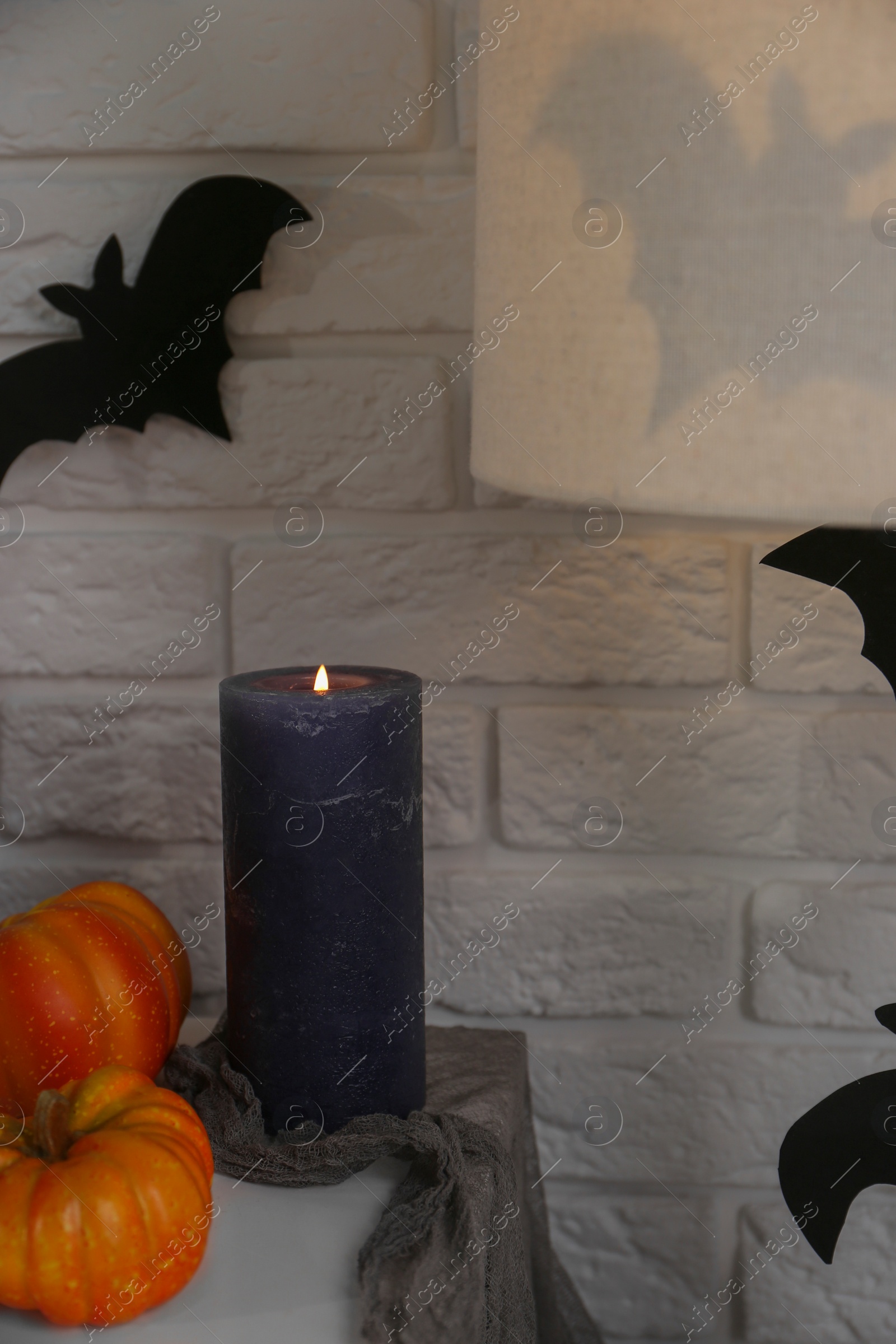 Photo of Fireplace with different Halloween decor indoors. Festive interior