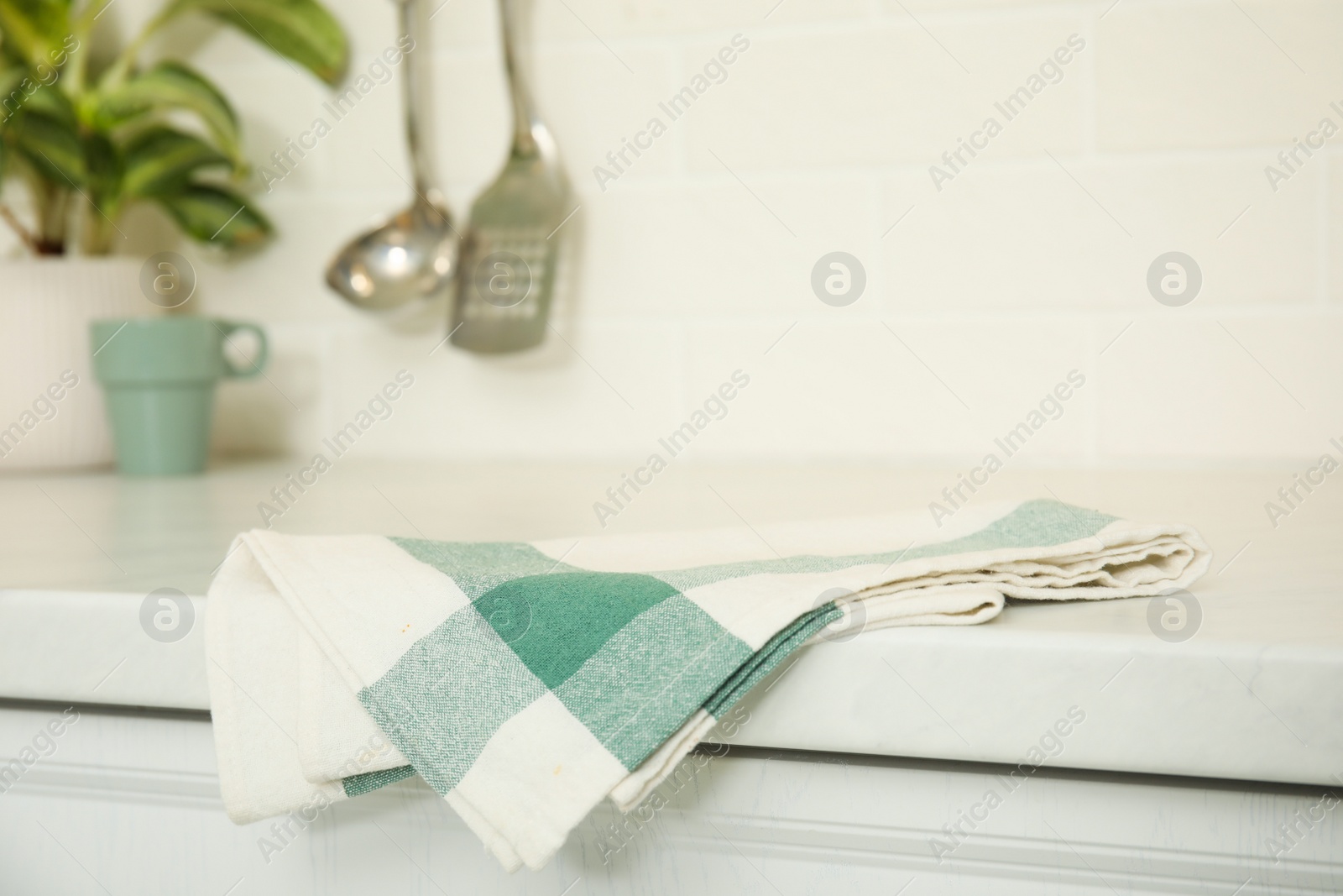 Photo of Clean towel on white countertop in kitchen