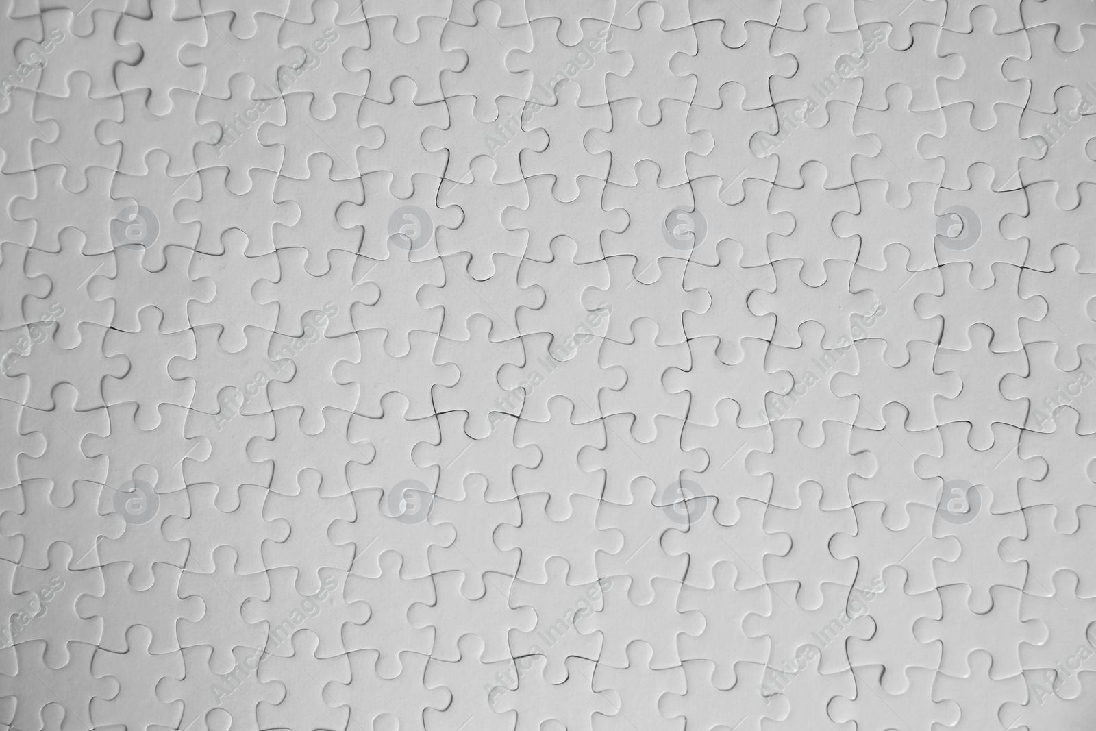 Photo of Blank white puzzles as background, top view