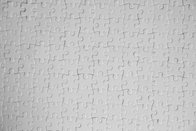 Photo of Blank white puzzles as background, top view