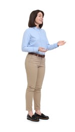 Happy businesswoman in blue shirt and beige pants on white background