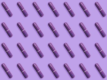 Many tampons on violet background, flat lay 