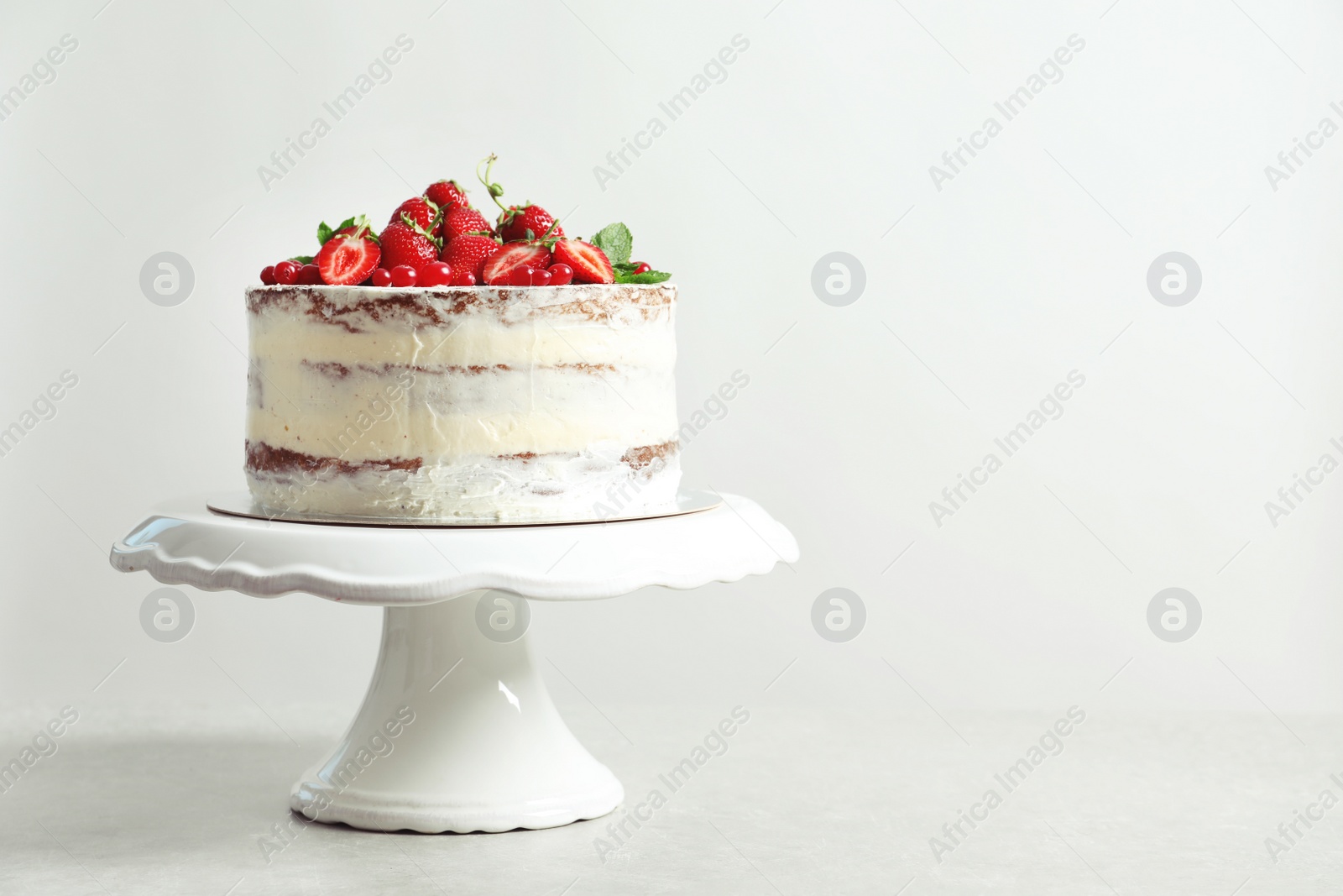 Photo of Delicious homemade cake with fresh berries and space for text on light background