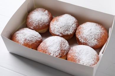 Delicious sweet buns in box on table, closeup