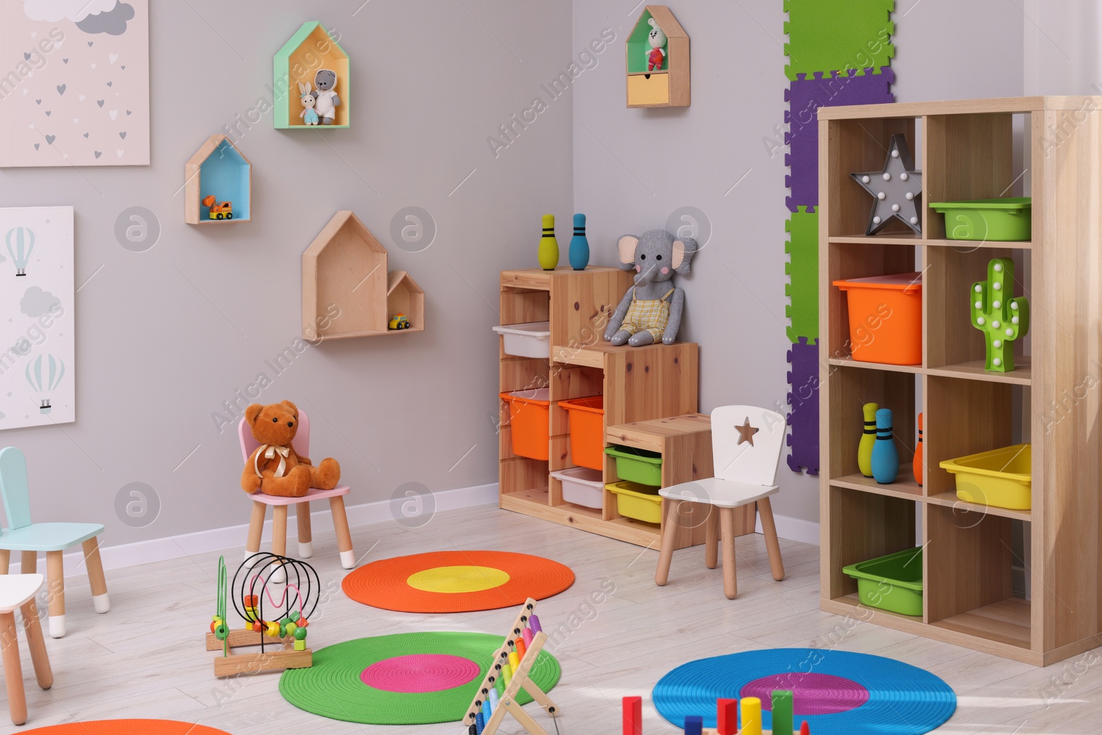 Photo of Child`s playroom with different toys and furniture. Cozy kindergarten interior