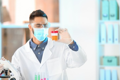 Photo of Young scientist working in laboratory. Chemical analysis