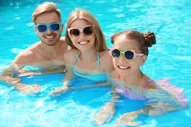 Photo of Happy family in pool on sunny day