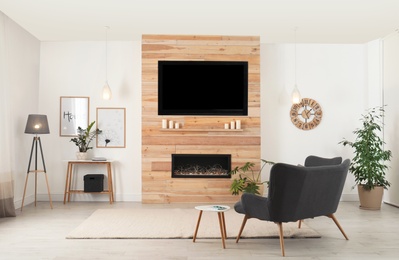 Photo of Living room interior with decorative fireplace in wooden wall