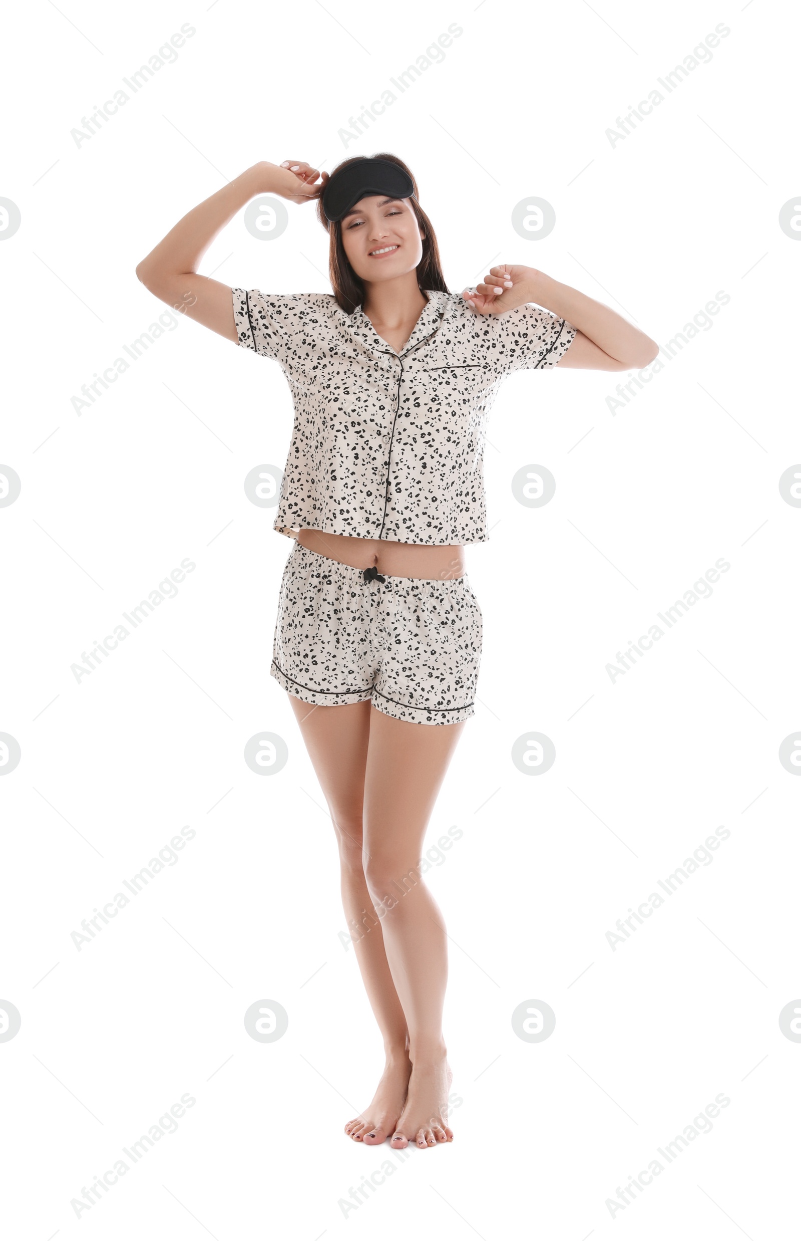 Photo of Beautiful woman wearing sleeping mask on white background. Bedtime