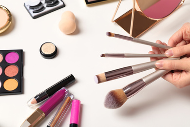 Photo of Beauty blogger with set of make up brushes at table, closeup