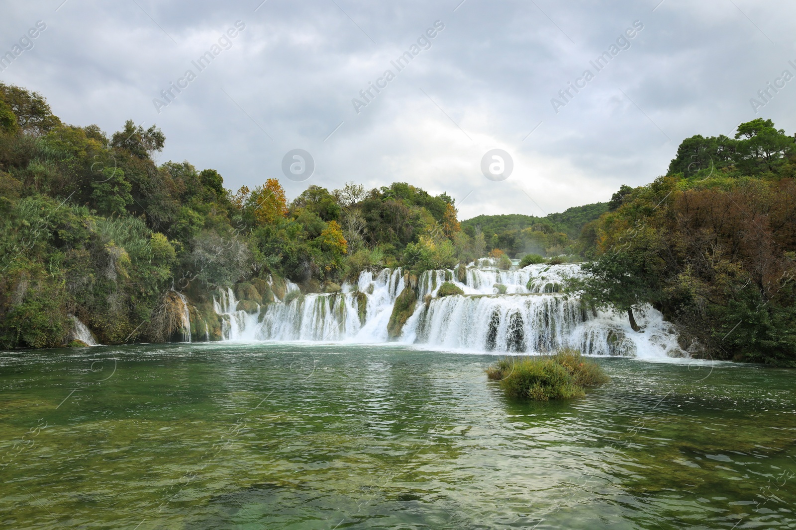 Photo of Picturesque view of beautiful waterfall and rocks outdoors