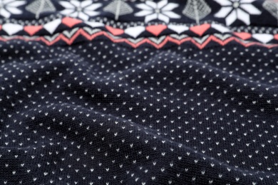 Texture of cozy warm sweater as background, closeup