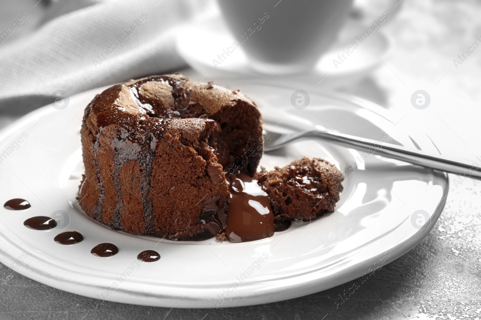 Photo of Plate of delicious fresh fondant with hot chocolate on table. Lava cake recipe