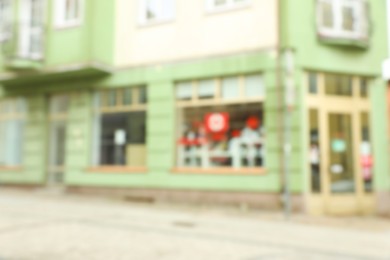 Photo of Blurred view of city street with modern store. Bokeh effect