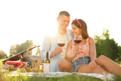 Photo of Happy couple having picnic in park on sunny day