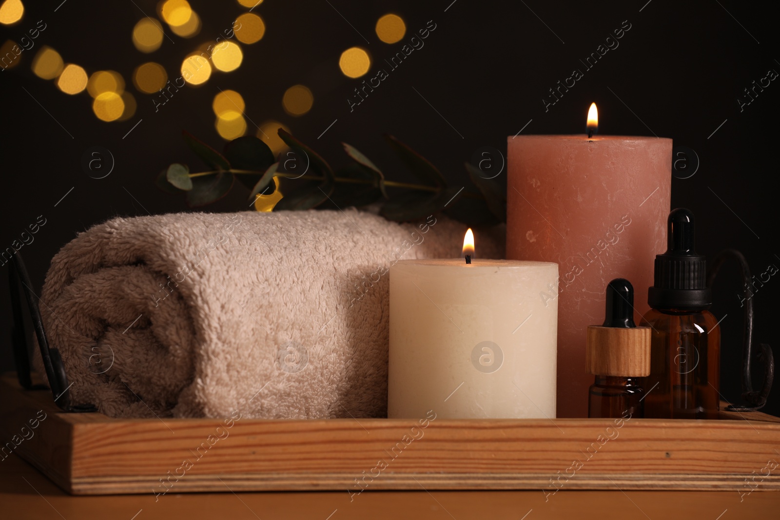 Photo of Beautiful composition with different spa products on table against blurred lights, closeup