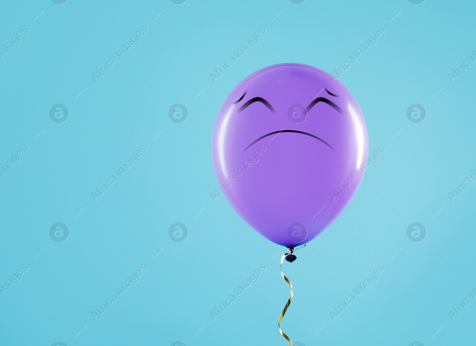 Image of Purple balloon with sad face on light blue background. Space for text