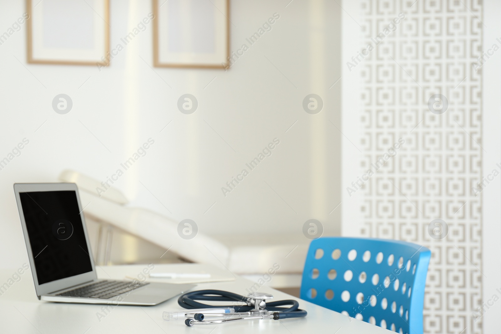 Photo of Doctor's workplace with modern laptop in medical office