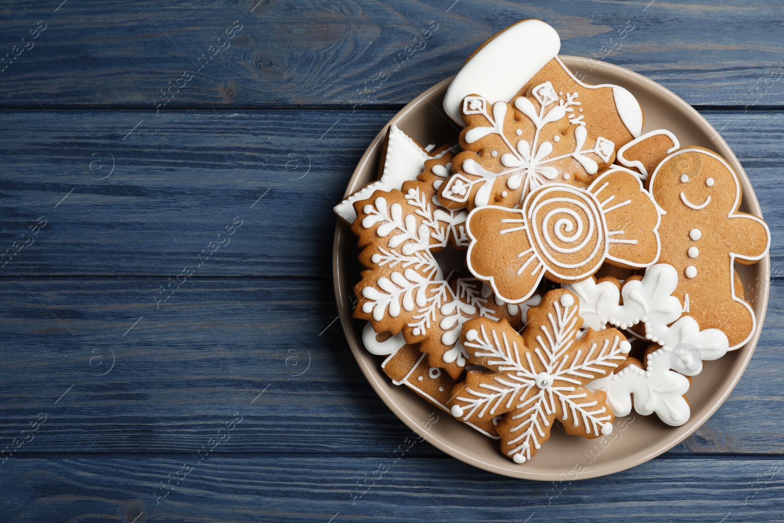 Photo of Delicious Christmas cookies on blue wooden table, top view. Space for text