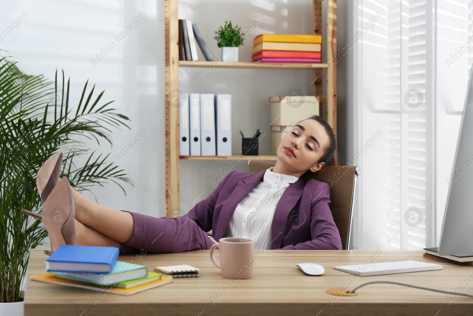 Photo of Lazy employee sleeping at table in office