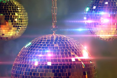 Shiny bright disco balls on under color lights