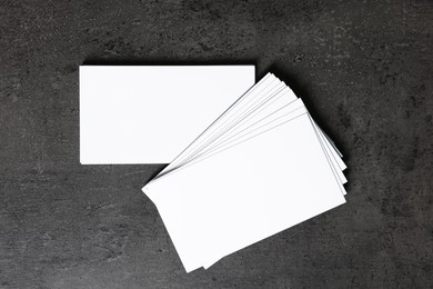 Blank business cards on grey textured background, top view. Mockup for design