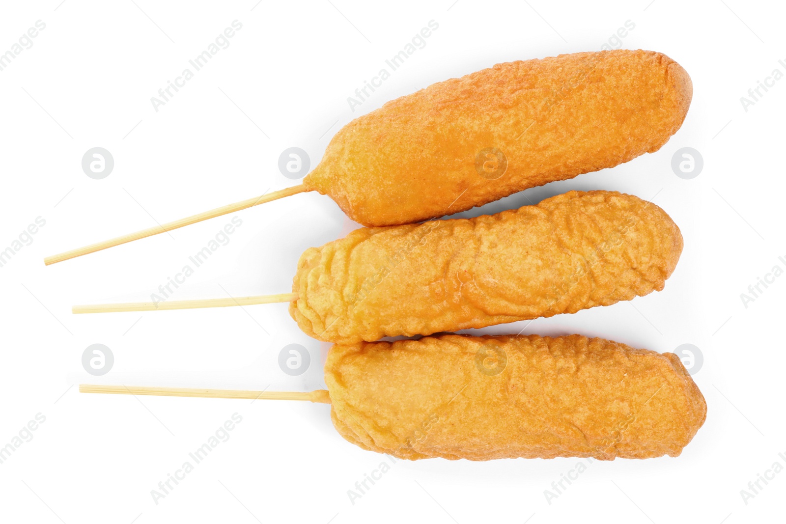 Photo of Delicious deep fried corn dogs isolated on white, top view