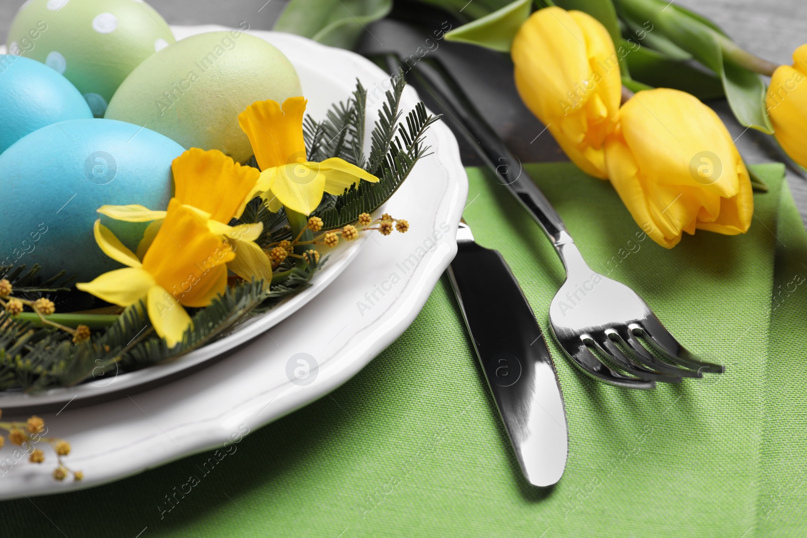 Photo of Festive Easter table setting with eggs, closeup